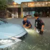 As floodwaters rage, a witness recalls: 'A car, its wheels spinning uselessly, being dragged by the unrelenting current of Cedar Brook'