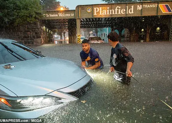 As floodwaters rage, a witness recalls: 'A car, its wheels spinning uselessly, being dragged by the unrelenting current of Cedar Brook'