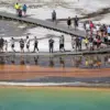 Tourist Violates Yellowstone Regulations by Disturbing Grand Prismatic Spring's Bacterial Mats, Prompting Calls for Enforcement