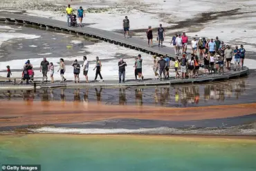 Tourist Violates Yellowstone Regulations by Disturbing Grand Prismatic Spring's Bacterial Mats, Prompting Calls for Enforcement