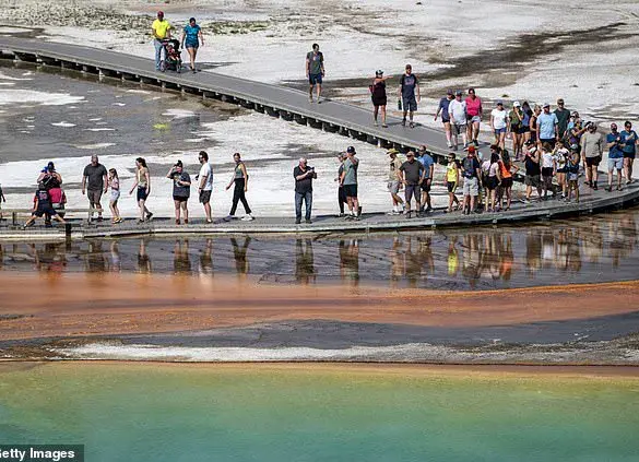 Tourist Violates Yellowstone Regulations by Disturbing Grand Prismatic Spring's Bacterial Mats, Prompting Calls for Enforcement